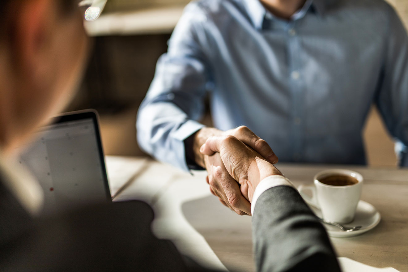 bank lending officer and business owner shake hands