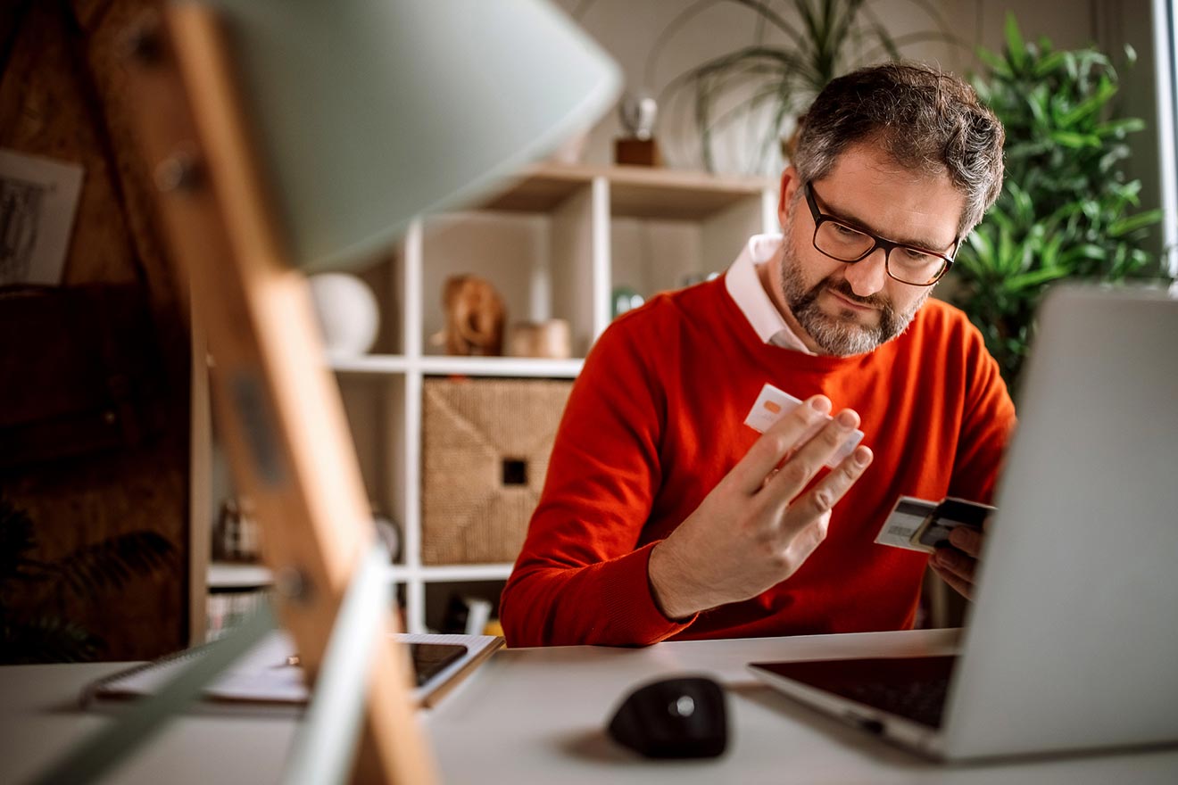 man looking at his credit cards