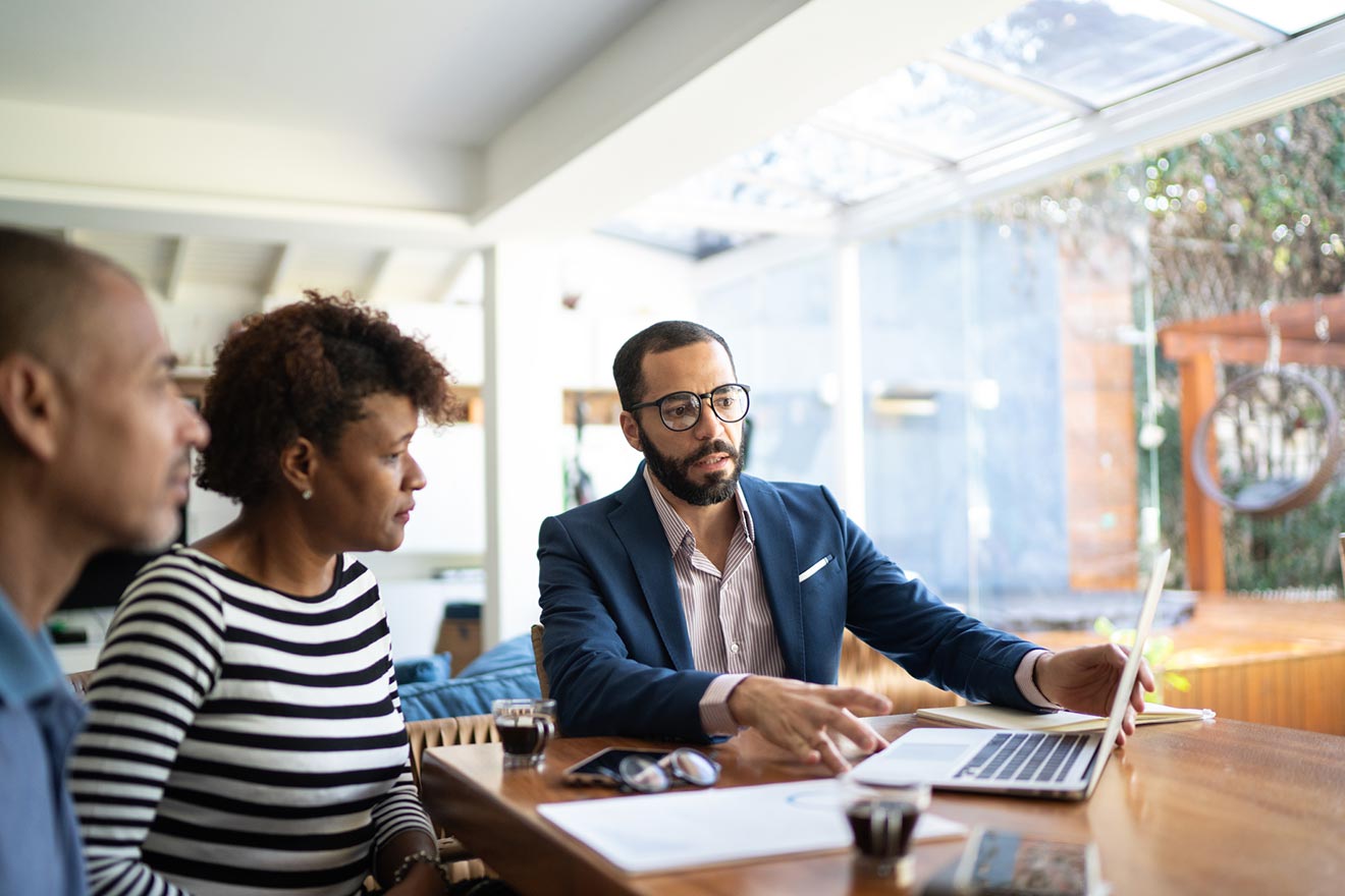 couple reviewing retirement plan with bank representative