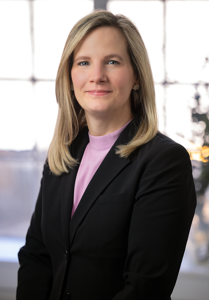 An image of Emily M. Newcamp, the Bank's SVP, Retail Banking Manager, smiling with a window in the background.