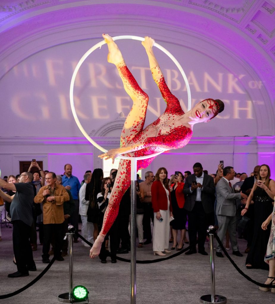 A performer from Cirque Du Jour entertains the crowd at The First Bank of Greenwich’s B2B event held in downtown Greenwich last Thursday. (Photo by Liz Leamy)