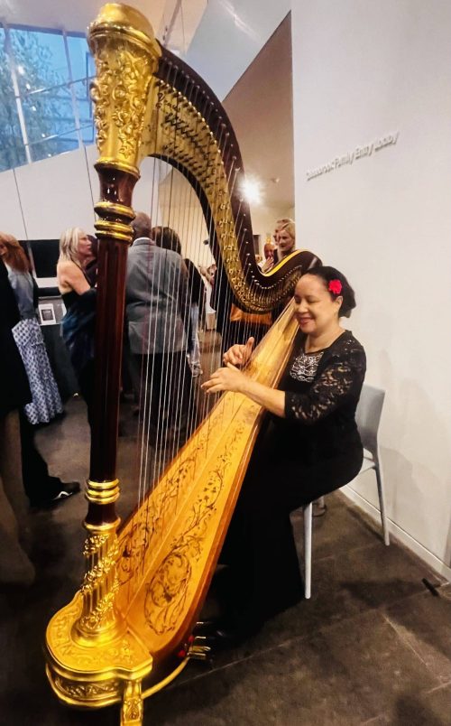 Nina Bogomas, the talented harpist, plays at The First Bank of Greenwich celebratory event honoring Jodi DeCrenza and her artwork at The Bruce Museum last week. 